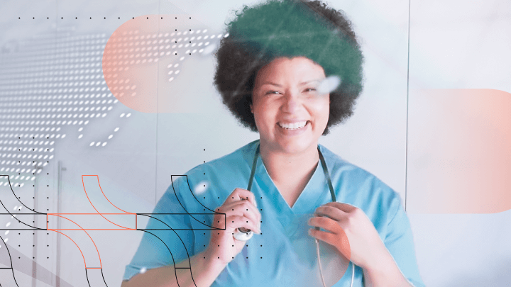 Smiling female doctor with afro hairstyle holding a stethoscope, wearing blue scrubs.