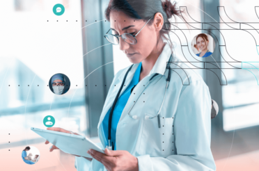 A female doctor looking at a tablet.