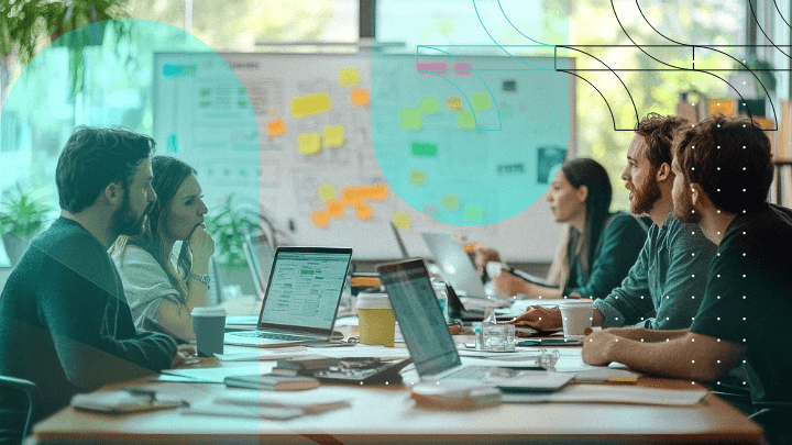 Team of professionals discussing a project during a meeting, seated around a table in an office.