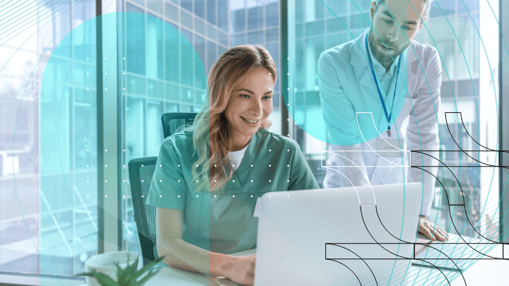 Two doctors discussing information on a laptop in a modern office, demonstrating collaboration.