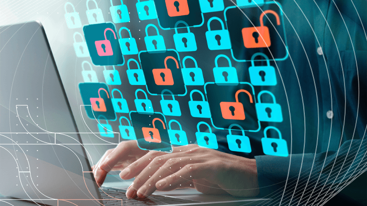 Person working on a laptop with lock icons appearing, symbolizing cybersecurity.