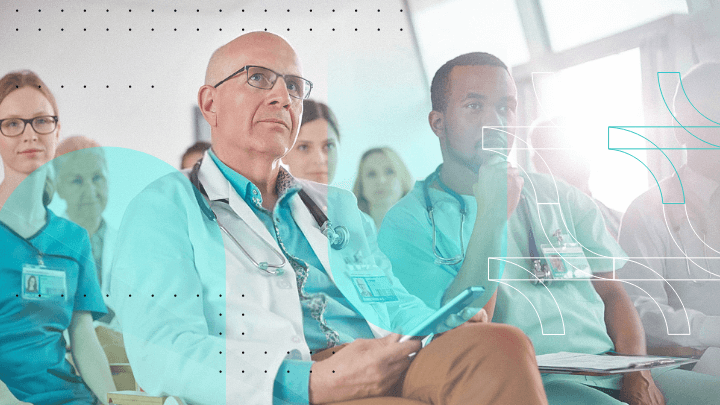 Group of medical professionals attending a lecture, participating in a seminar or conference.