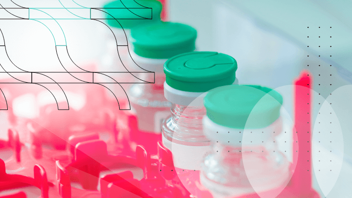 Row of medicine vials in a rack, representing pharmaceutical production.